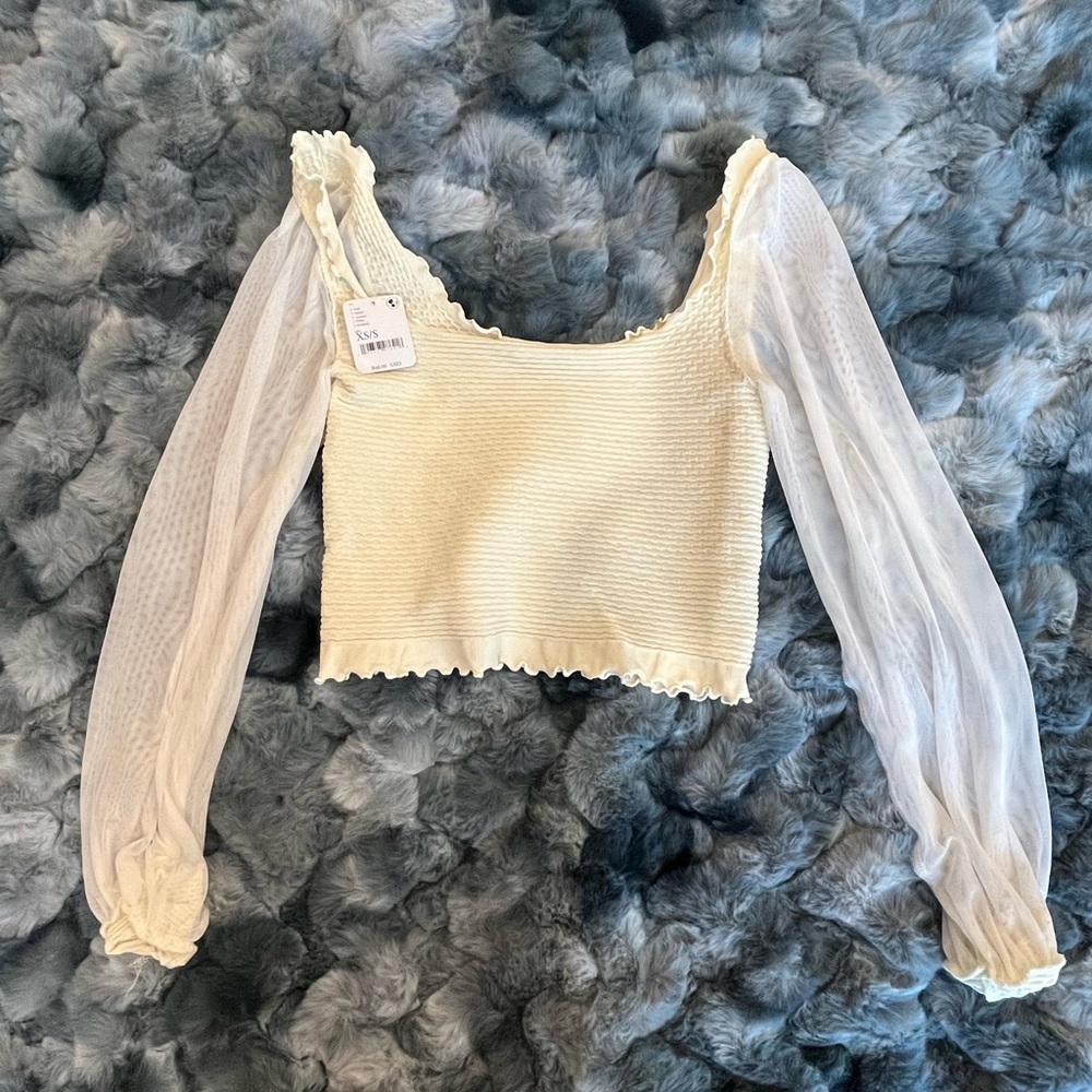 Cute, cream colored, sheer sleeved, textured center, cropped top.